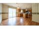 An open kitchen and dining area with hardwood floors and a sliding glass door to the outside at 3611 Owster Ln, Indianapolis, IN 46237