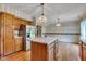 Kitchen showcasing oak cabinets, an island, and stainless steel appliances for a modern touch at 3611 Owster Ln, Indianapolis, IN 46237