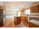 Kitchen featuring a center island, wooden cabinets, stainless steel appliances, and hardwood floors at 3611 Owster Ln, Indianapolis, IN 46237