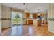 Bright kitchen featuring wooden cabinets, a center island, and sliding glass doors leading to the backyard at 3611 Owster Ln, Indianapolis, IN 46237