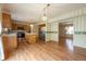 This kitchen includes a center island, wooden cabinets, stainless steel appliances, and wood floors at 3611 Owster Ln, Indianapolis, IN 46237