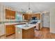 Kitchen with a center island, oak cabinets, and modern appliances at 3611 Owster Ln, Indianapolis, IN 46237