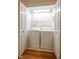 Laundry closet with hardwood floors, washer, dryer, and lighting at 3611 Owster Ln, Indianapolis, IN 46237