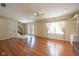 Open-concept living room with hardwood floors, staircase access, and great natural light at 3611 Owster Ln, Indianapolis, IN 46237