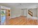 Spacious living room with hardwood floors, offering an open layout to the kitchen and access to the staircase at 3611 Owster Ln, Indianapolis, IN 46237