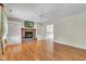 Bright living room boasts hardwood floors, a brick fireplace with built-ins, and a ceiling fan for comfort at 3611 Owster Ln, Indianapolis, IN 46237