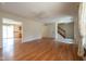 A spacious living room features wood floors, a ceiling fan, and an open floor plan leading to the kitchen at 3611 Owster Ln, Indianapolis, IN 46237
