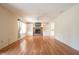 A spacious living room featuring hardwood floors, a brick fireplace, and built-in shelving at 3611 Owster Ln, Indianapolis, IN 46237