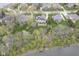 Aerial view of the residence, highlighting its expansive lot, lush landscaping, and outdoor amenities near pond at 3837 Penzance Pl, Carmel, IN 46032