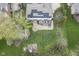 Aerial view of backyard with solar panels, patio, deck, fire pit, garden, and playground at 3837 Penzance Pl, Carmel, IN 46032