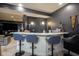 Finished bar area with barstools, overhead lighting and Notre Dame decor at 3837 Penzance Pl, Carmel, IN 46032