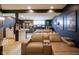 Finished basement with a bar, theater seating and themed decor offers space for recreation and relaxation at 3837 Penzance Pl, Carmel, IN 46032