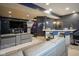 Finished basement boasts a entertainment area with a bar, seating, and mounted television for entertainment at 3837 Penzance Pl, Carmel, IN 46032