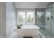 Luxurious bathroom featuring a standalone tub and walk-in shower with designer tile at 3837 Penzance Pl, Carmel, IN 46032