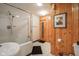 Bathroom featuring a shower and separate sauna with wood paneled walls, offering relaxation and convenience at 3837 Penzance Pl, Carmel, IN 46032