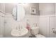 Charming powder room with pedestal sink, oval mirror, and decorative accents creating a cozy atmosphere at 3837 Penzance Pl, Carmel, IN 46032