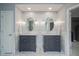 Elegant bathroom with dual vanities, stylish mirrors, and modern lighting at 3837 Penzance Pl, Carmel, IN 46032
