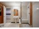 Bathroom features a tiled shower with built-in seating and a pedestal sink with a view to another room at 3837 Penzance Pl, Carmel, IN 46032
