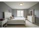 Comfortable bedroom with white furniture, soft carpet, and natural light at 3837 Penzance Pl, Carmel, IN 46032