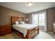 Bedroom with a wooden bed frame, brown walls, and neutral carpet at 3837 Penzance Pl, Carmel, IN 46032