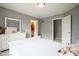 Bright bedroom with a large window, white furniture, and walk in closet at 3837 Penzance Pl, Carmel, IN 46032