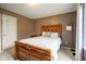Bedroom with a wooden bed frame, brown walls, and neutral carpet at 3837 Penzance Pl, Carmel, IN 46032