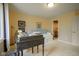 Bedroom with large window, daybed with turquoise pillows, desk, and walk-in closet at 3837 Penzance Pl, Carmel, IN 46032