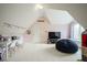 Bonus room with a TV, beanbag chair, a window, and white desk with chairs at 3837 Penzance Pl, Carmel, IN 46032