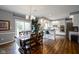 Inviting dining area with an elegant chandelier, a modern table, and a sliding door at 3837 Penzance Pl, Carmel, IN 46032