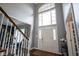 Grand foyer with a two-story window, hardwood floors, and staircase at 3837 Penzance Pl, Carmel, IN 46032