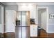 The kitchen with a stainless steel refrigerator and white cabinetry offers both functionality and style at 3837 Penzance Pl, Carmel, IN 46032