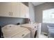 Functional laundry room with washer, dryer, sink, and storage cabinets, providing convenience and organization at 3837 Penzance Pl, Carmel, IN 46032