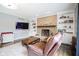 Inviting living room with brick fireplace, built-in shelving, and comfortable seating at 3837 Penzance Pl, Carmel, IN 46032