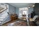 Stylish living room with hardwood floors, leather sofa, and a view into the dining room at 3837 Penzance Pl, Carmel, IN 46032