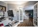 Home office featuring a modern desk setup, hardwood floors, and a view to the staircase at 3837 Penzance Pl, Carmel, IN 46032