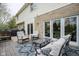 Back deck with outdoor seating overlooks the backyard, creating a perfect spot for relaxation and entertaining at 3837 Penzance Pl, Carmel, IN 46032