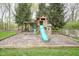 Backyard playground with a slide, swing, and wooden play structure at 3837 Penzance Pl, Carmel, IN 46032