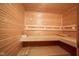 Wood paneled sauna with benches and a thermometer on the wall, perfect for relaxation and wellness at 3837 Penzance Pl, Carmel, IN 46032