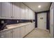 Finished storage area with multiple cabinets, a counter, and adjacent doorway at 3837 Penzance Pl, Carmel, IN 46032