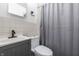 Bathroom with grey vanity, toilet, tiled shower, and modern fixtures at 3909 Aloda St, Indianapolis, IN 46203