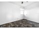 An empty bedroom with a window, door, and modern flooring at 3909 Aloda St, Indianapolis, IN 46203
