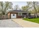 Charming brick home featuring a gray roof, a cozy front porch, and a well-maintained front yard at 3909 Aloda St, Indianapolis, IN 46203