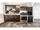 A kitchen featuring dark wood cabinetry, stainless steel appliances, and neutral countertops at 3909 Aloda St, Indianapolis, IN 46203