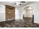 Inviting living room featuring a stone accent wall, arched doorways, and modern ceiling fan at 3909 Aloda St, Indianapolis, IN 46203