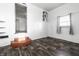 Bright living room featuring a window, wood-look floors, and an arched doorway to an adjacent room at 3909 Aloda St, Indianapolis, IN 46203