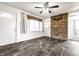 Bright living room with a stone accent wall, stylish flooring, and ample natural light at 3909 Aloda St, Indianapolis, IN 46203