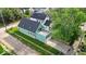 Aerial shot of the home showing a private roof deck, fenced yard, modern siding, and a detached two-car garage at 401 Sanders St, Indianapolis, IN 46225