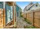 Stone path along the house with a wooden fence and green landscaping at 401 Sanders St, Indianapolis, IN 46225