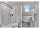 Modern bathroom features sleek tile shower, toilet, and sink with a skylight that provides natural light at 401 Sanders St, Indianapolis, IN 46225