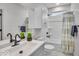 Bright bathroom featuring a modern vanity, tub with shower, and neutral-toned decor at 401 Sanders St, Indianapolis, IN 46225